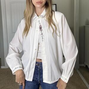 White vintage blouse with embroidered details on the collar and cuffs
